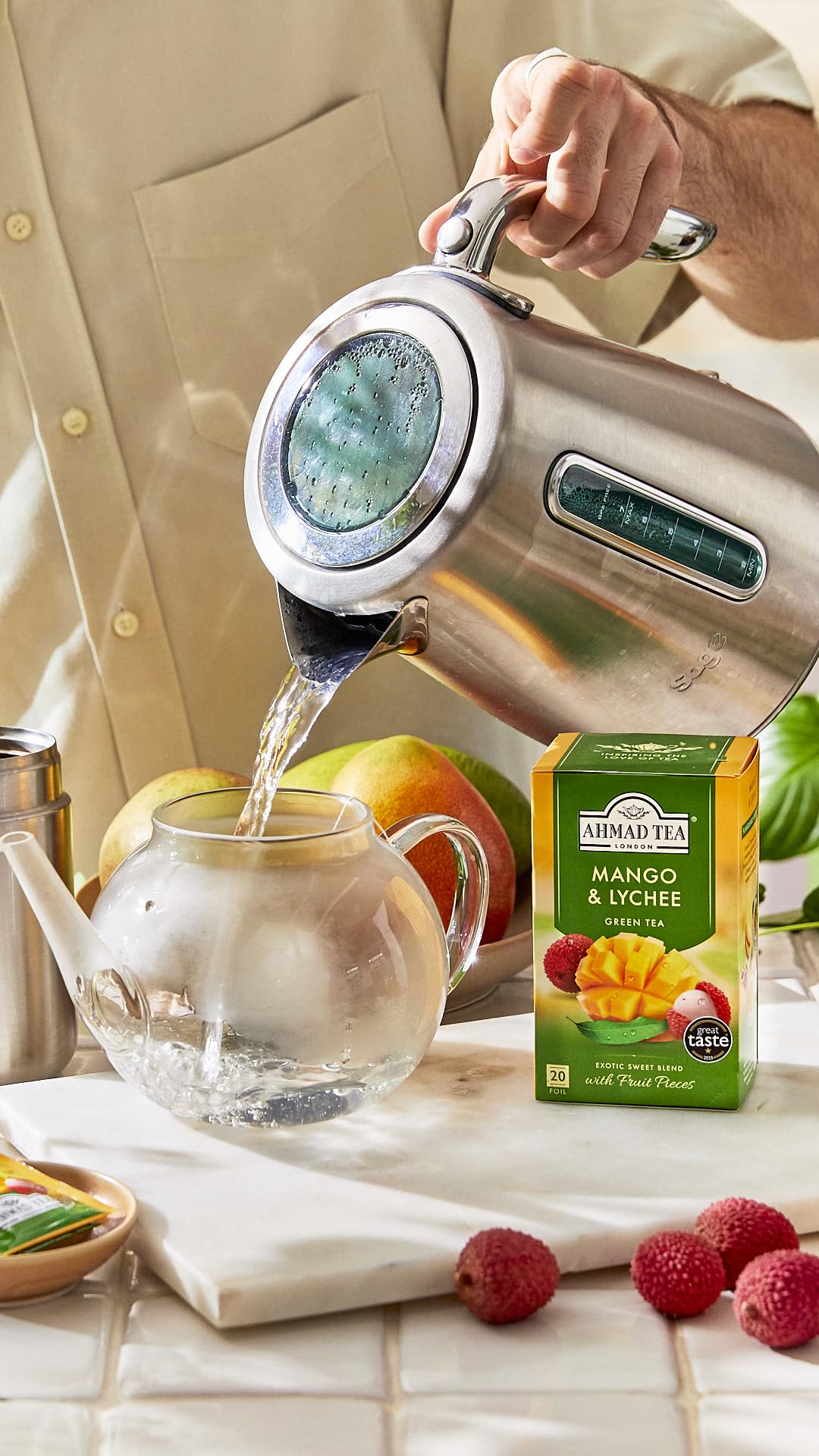 Ahmad Tea iced tea in glass with garnish, displays refreshing tropical serve