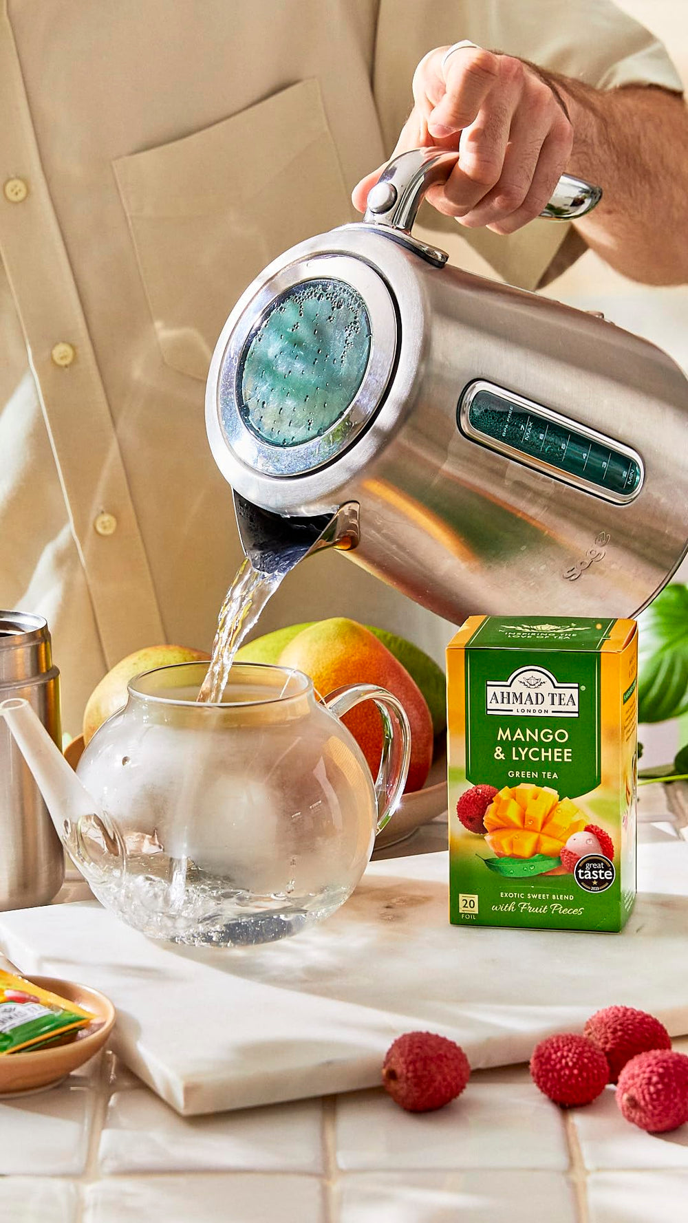 Ahmad Tea iced tea in glass with garnish, displays refreshing tropical serve