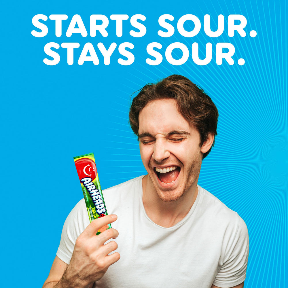 Close-up of Airheads Sour Watermelon taffy texture highlighting airy chew and sour coating