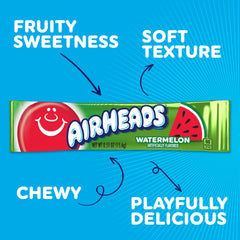 Hand holding an Airheads watermelon bar to show scale and portion convenience
