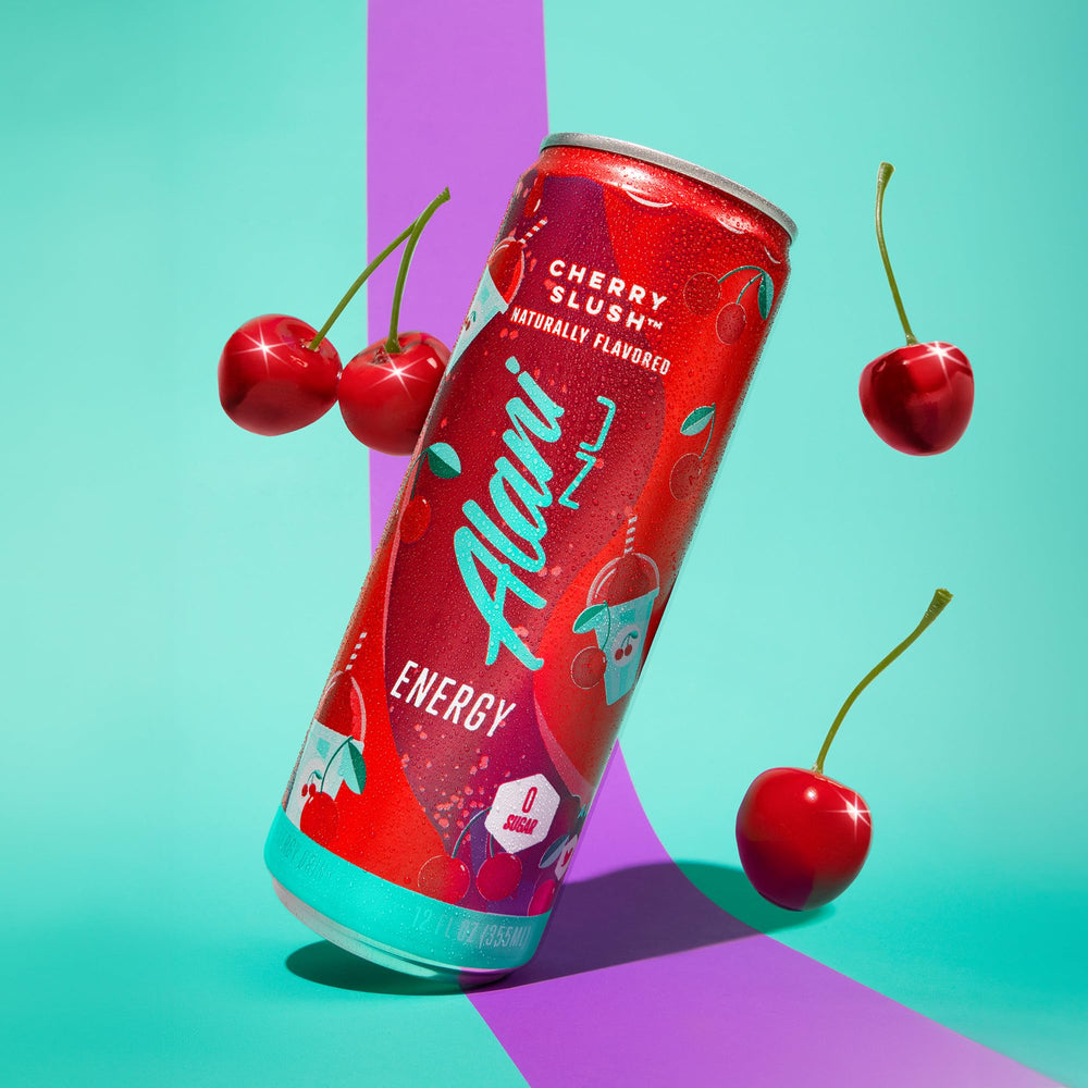 Alani Nu cherry slush enjoyed outdoors by a person smiling, captures on-the-go mood and flavor