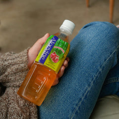 Aloevine bottles in a refrigerator lifestyle shot showing ready-to-drink convenience and chilled refreshment