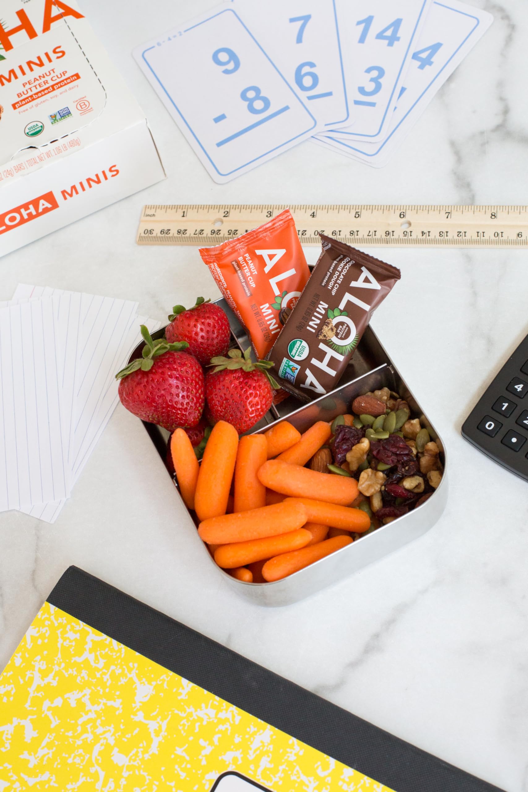 ALOHA mini bar beside phone demonstrating compact size and portion control benefit