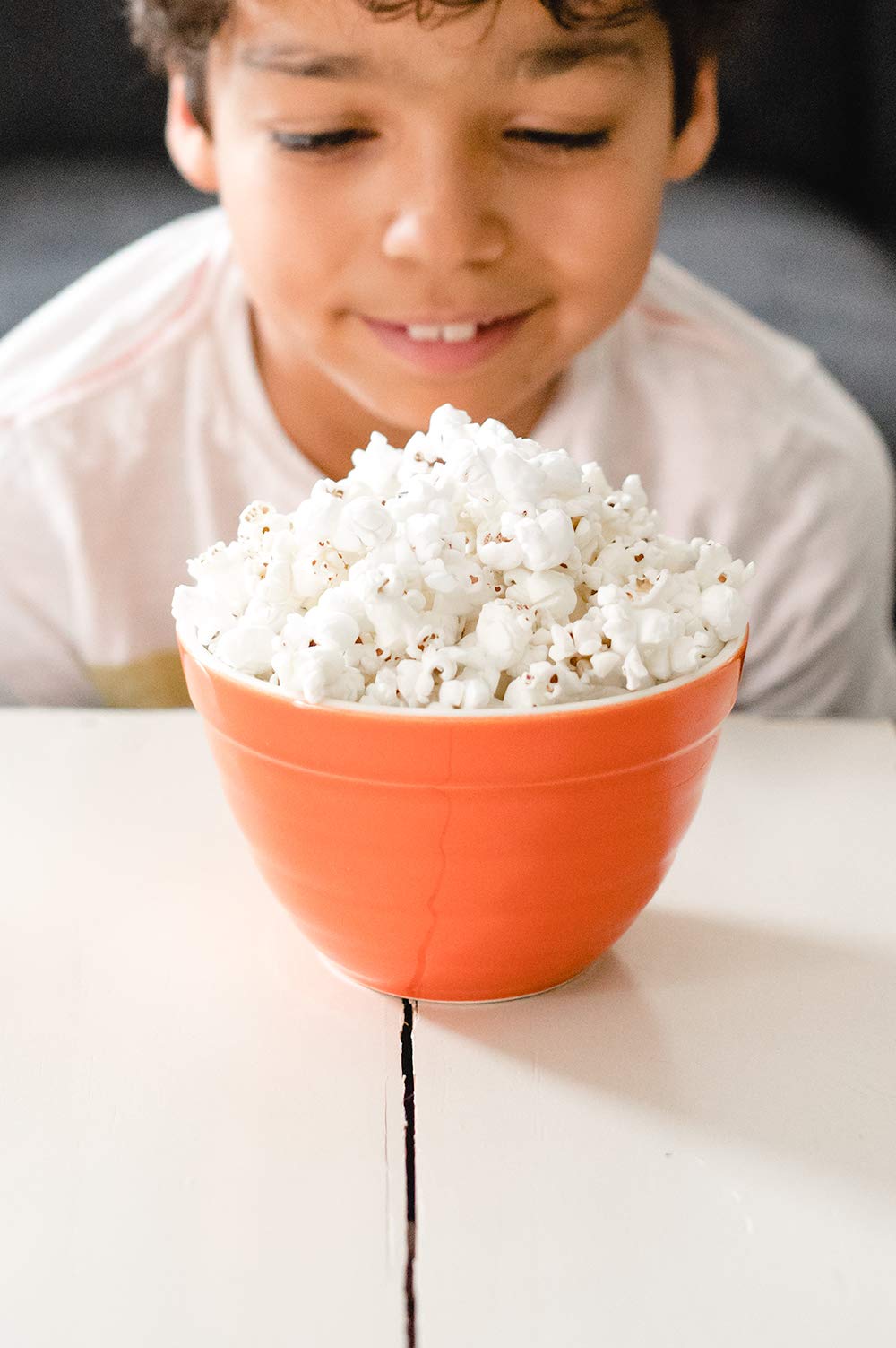 Family enjoying Amish Country Popcorn during a movie night, perfect for gatherings
