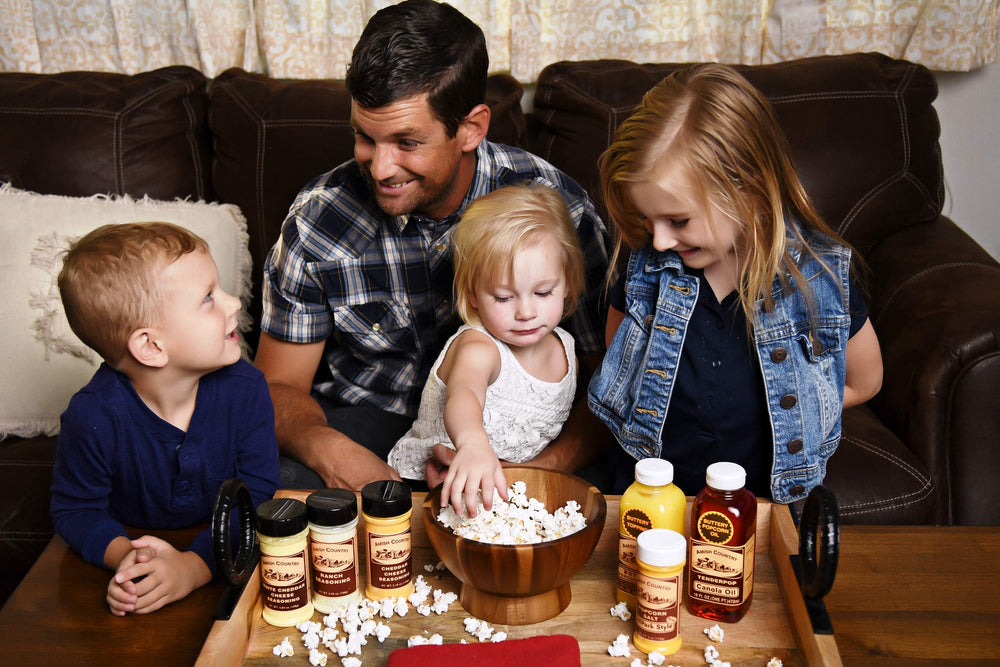 Pouring Amish Country Popcorn canola oil into measuring spoon for controlled flavor benefit