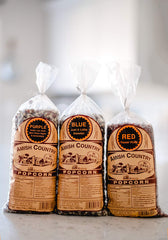 Amish Country Popcorn three bags laid flat displaying purple red and blue kernels for variety