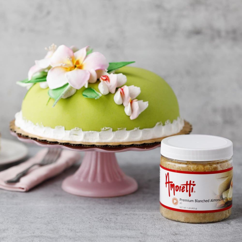 Hands kneading Amoretti paste into dough illustrating improved elasticity and flavor