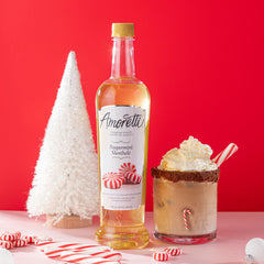 Amoretti peppermint syrup bottle beside a ruler for size comparison and economical serving benefit