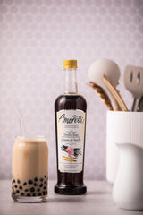 Amoretti syrup poured into coffee and cocktail showing versatile beverage use