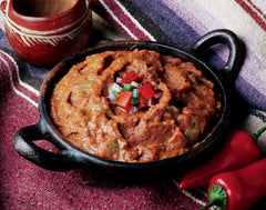 Amy's open can revealing creamy refried beans texture and green chile pieces for quick meals