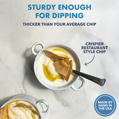 Ancient Crunch chip being dipped in salsa demonstrating scoopability