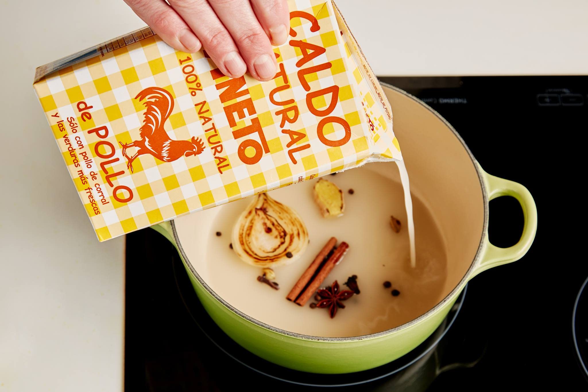 Fresh whole chicken and vegetables beside Aneto carton indicating real ingredients
