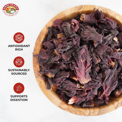 Angel Brand brewed hibiscus tea in clear glass showcasing rich red color and refreshing clarity