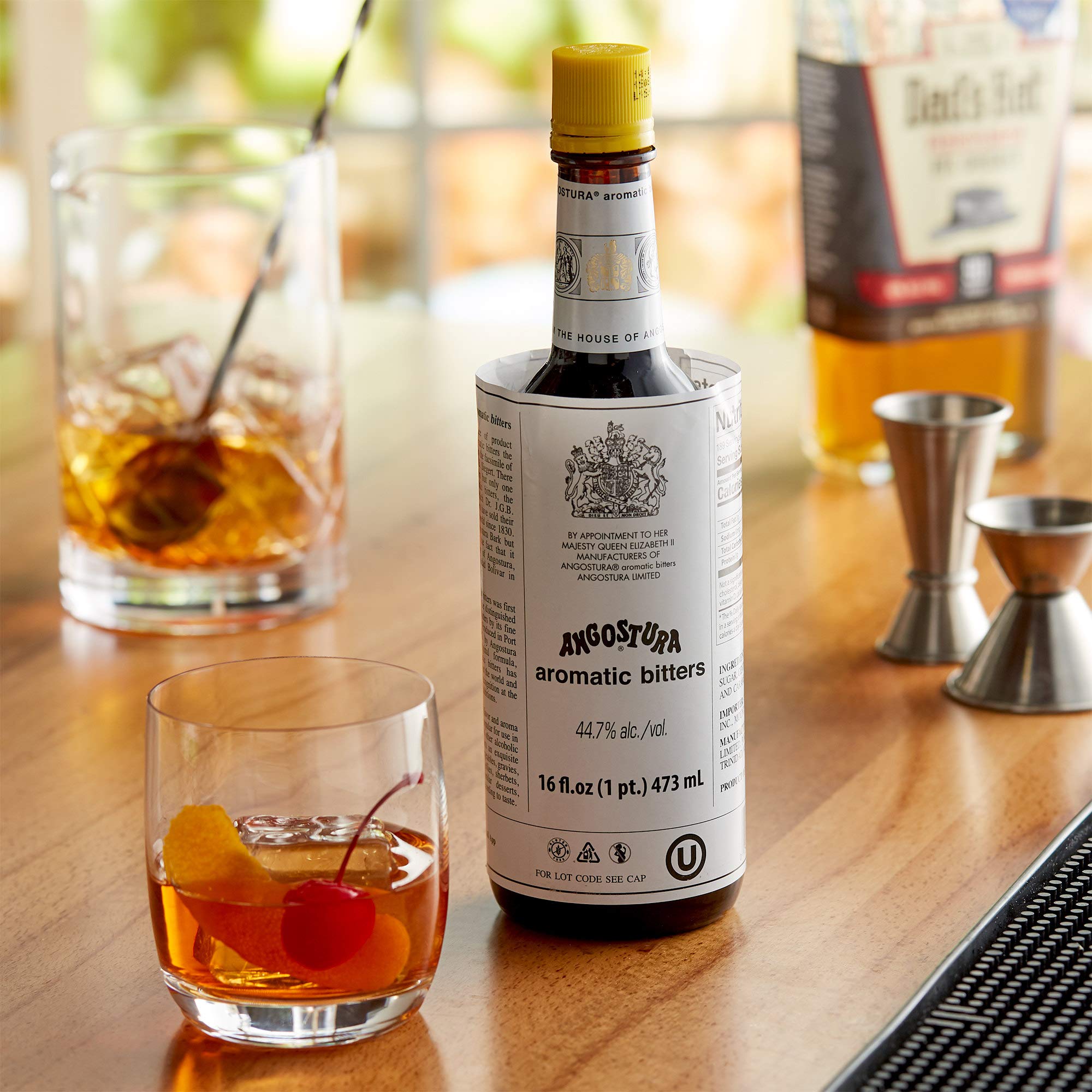 ANGOSTURA bitters pouring over ice to enhance cocktail flavor balance