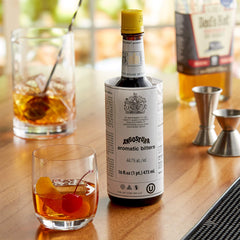 ANGOSTURA bitters pouring over ice to enhance cocktail flavor balance
