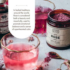 Anima Mundi pouring rose powder into latte, adds floral aroma and soft pink color
