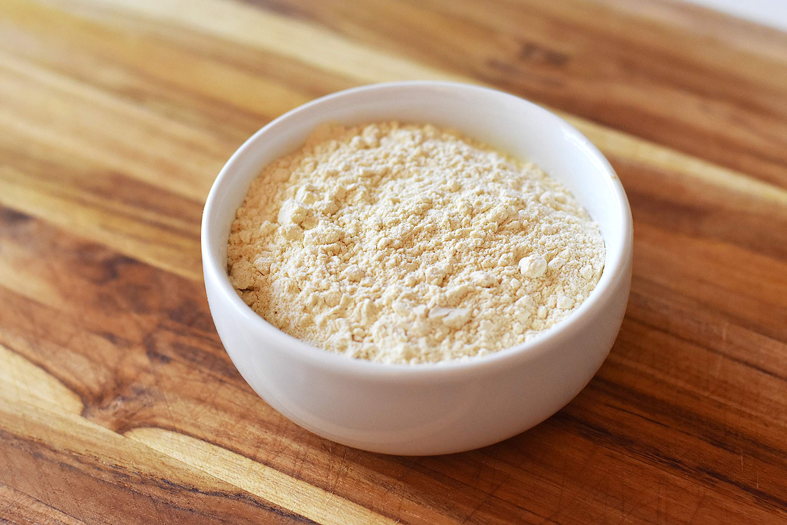 Measuring spoon with Anthony's wheat gluten beside scale for accurate recipe results
