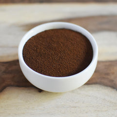 Anthony's sprinkling powder into brownie batter, enhances chocolate richness and aroma
