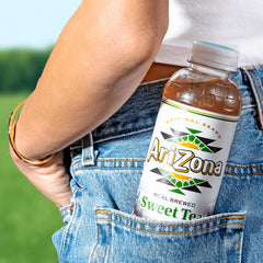 Hand holding a 16 oz AriZona Sweet Tea can to show size and portable convenience