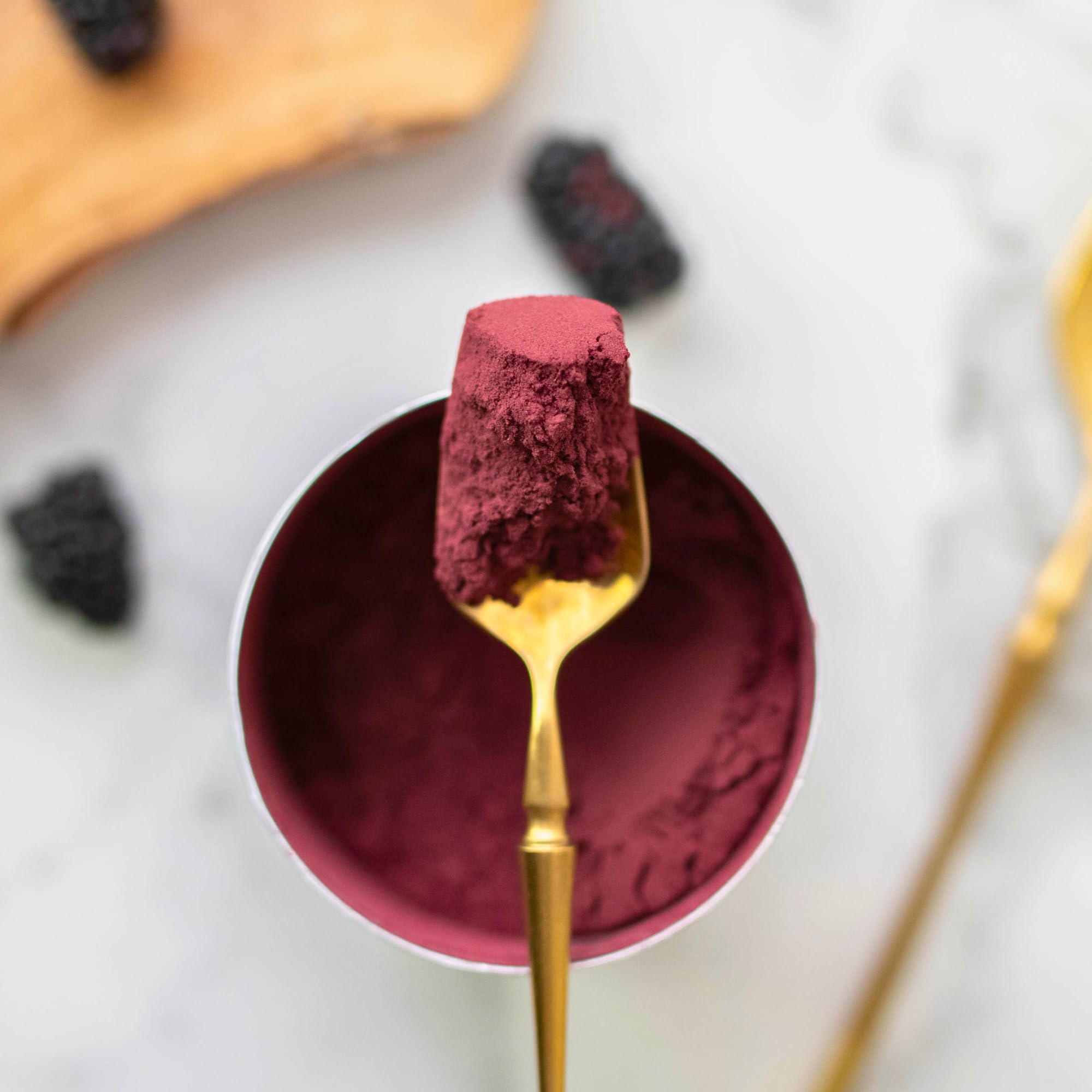 Aronia Original powder close-up texture revealing deep berry color and fine whole-berry grind benefit