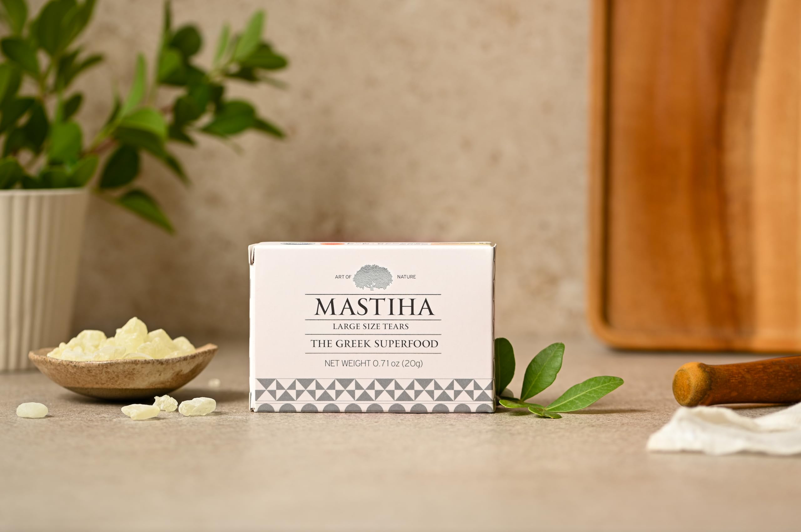 ART OF NATURE MASTIHA held in hands for scale showing 20g pack size convenience