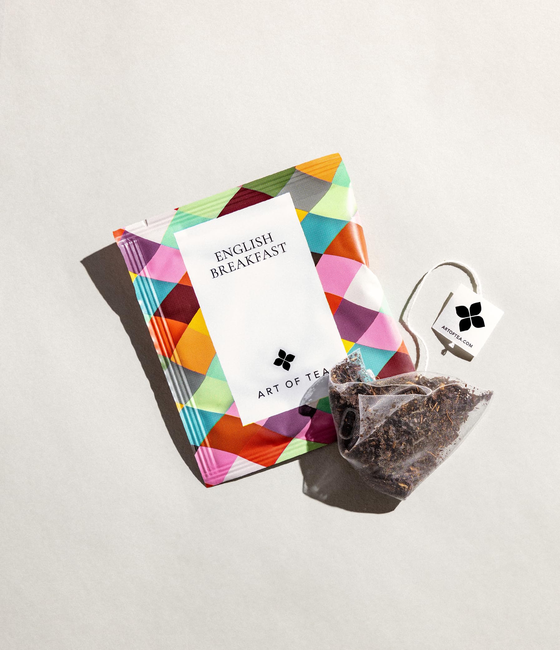 Art of Tea sachet beside standard mug illustrating single-serve convenience