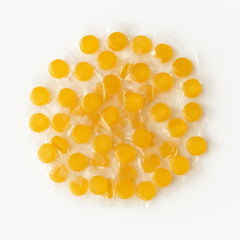 Assortit peach buttons beside a ruler showing piece size for portion planning