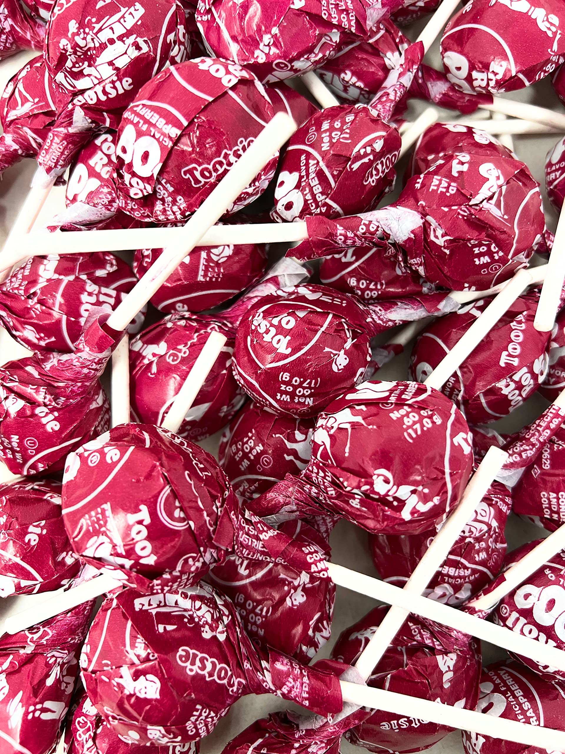 Assortit Tootsie Pops beside a ruler showing 36 oz bag scale for events