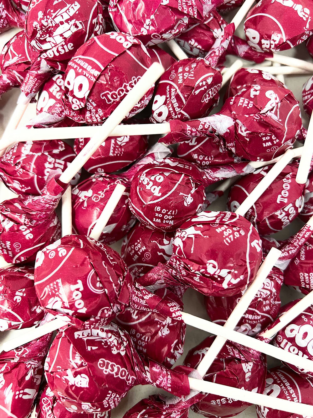 Assortit Tootsie Pops beside a ruler showing 36 oz bag scale for events