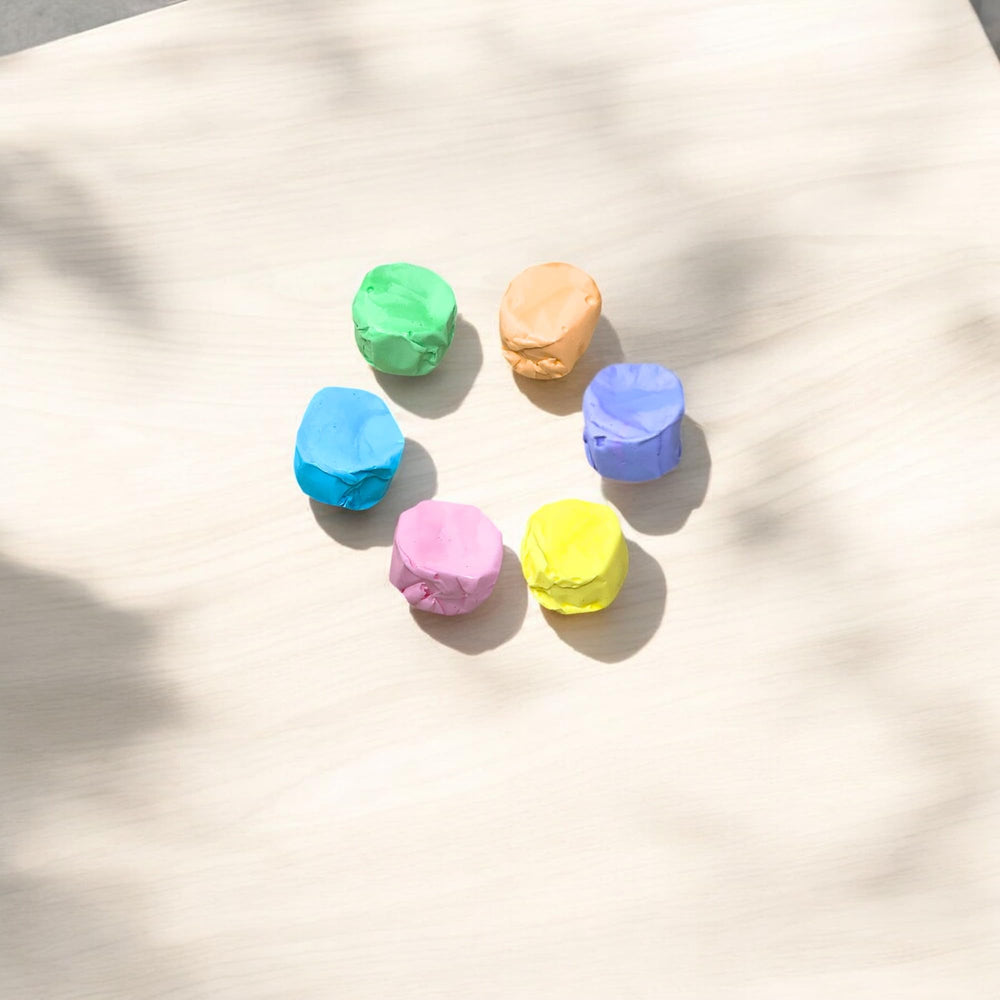 Assortit taffy in hand to show size and chewability for portion and scale reference