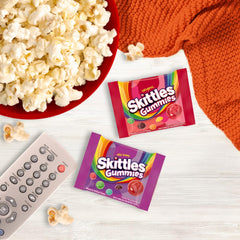 Assortit Skittles fun-size packs scattered highlighting convenient portioning