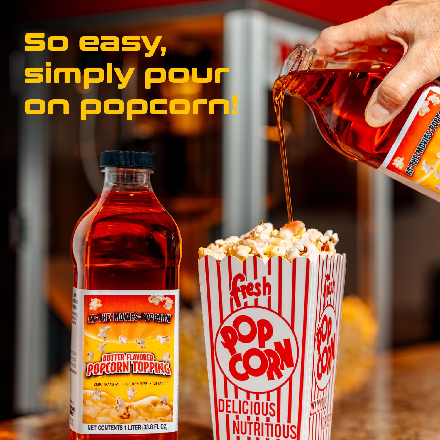 At-The-Movies-Popcorn 1-liter bottle next to a hand for scale, illustrates practical size