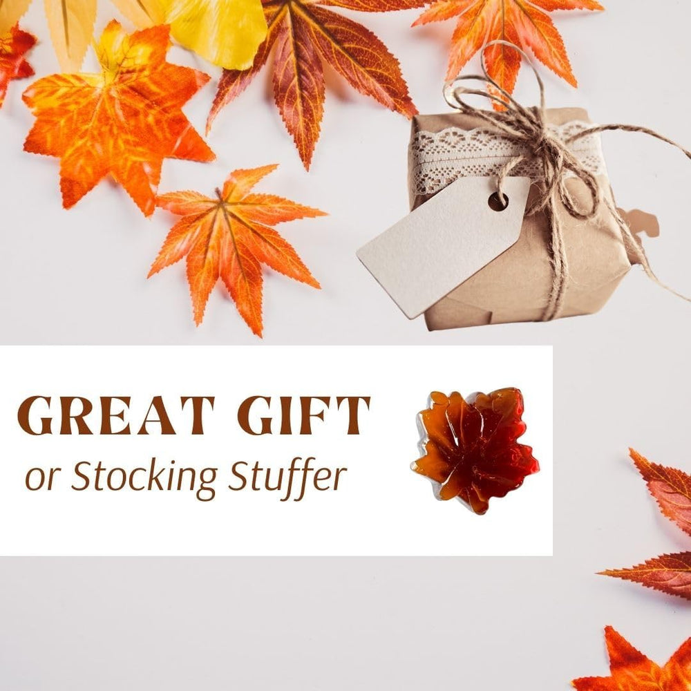 Atlantic Rush maple leaf candy on wooden surface conveying rustic Vermont origin