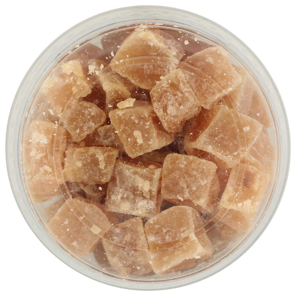 AURORA crystallized ginger beside a cup of tea suggesting comforting pairing