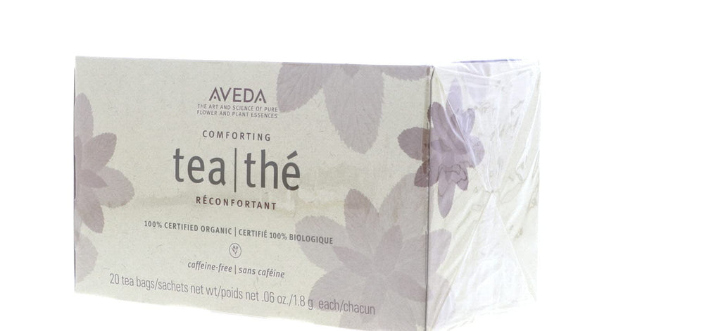 Aveda cup on a bedside table in a cozy setting suggesting evening relaxation