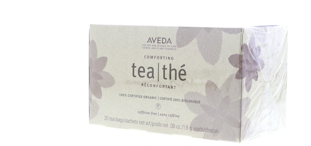 Aveda single sachet unwrapped beside teabag demonstrating portability and freshness
