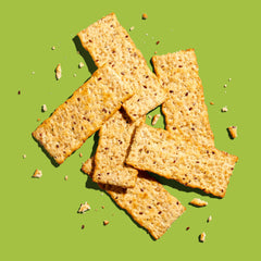 Back to Nature cracker in hand showing scale and portability for on-the-go snacks