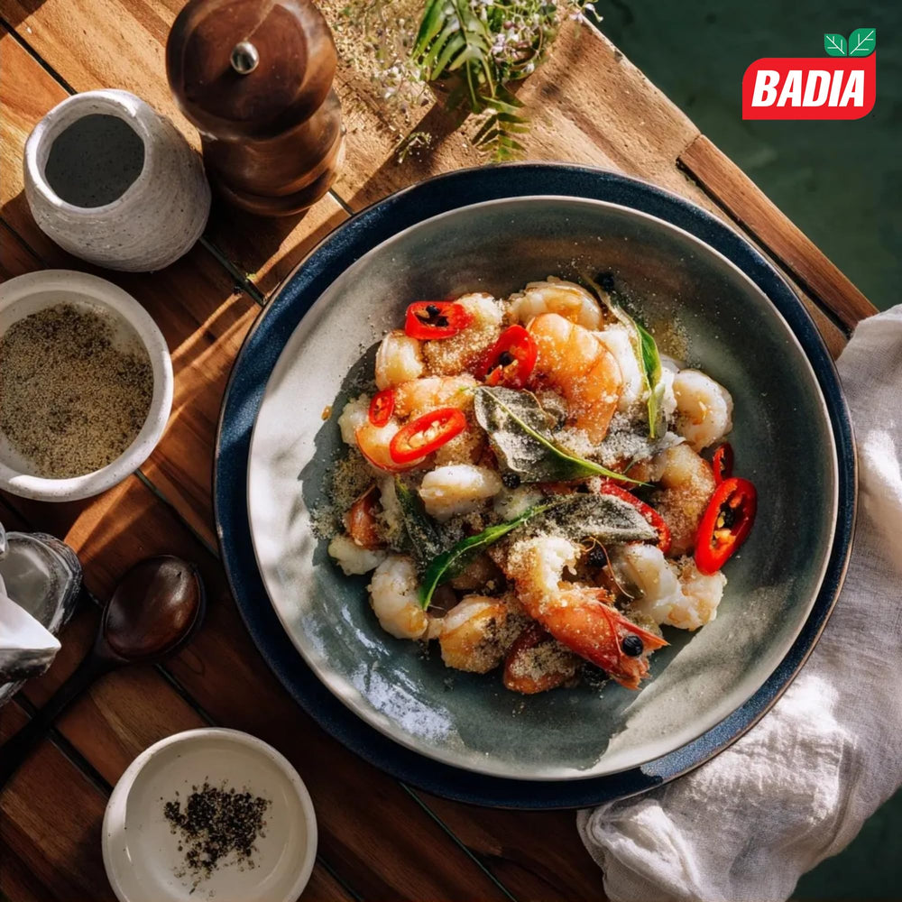Badia white pepper sprinkled into cream sauce showing brand in use for subtle, uniform seasoning