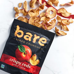 Bare apple chips beside whole Fuji apple to show real fruit origin