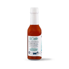 Barnacle Foods Habanero sauce pouring to show thickness and fruity heat
