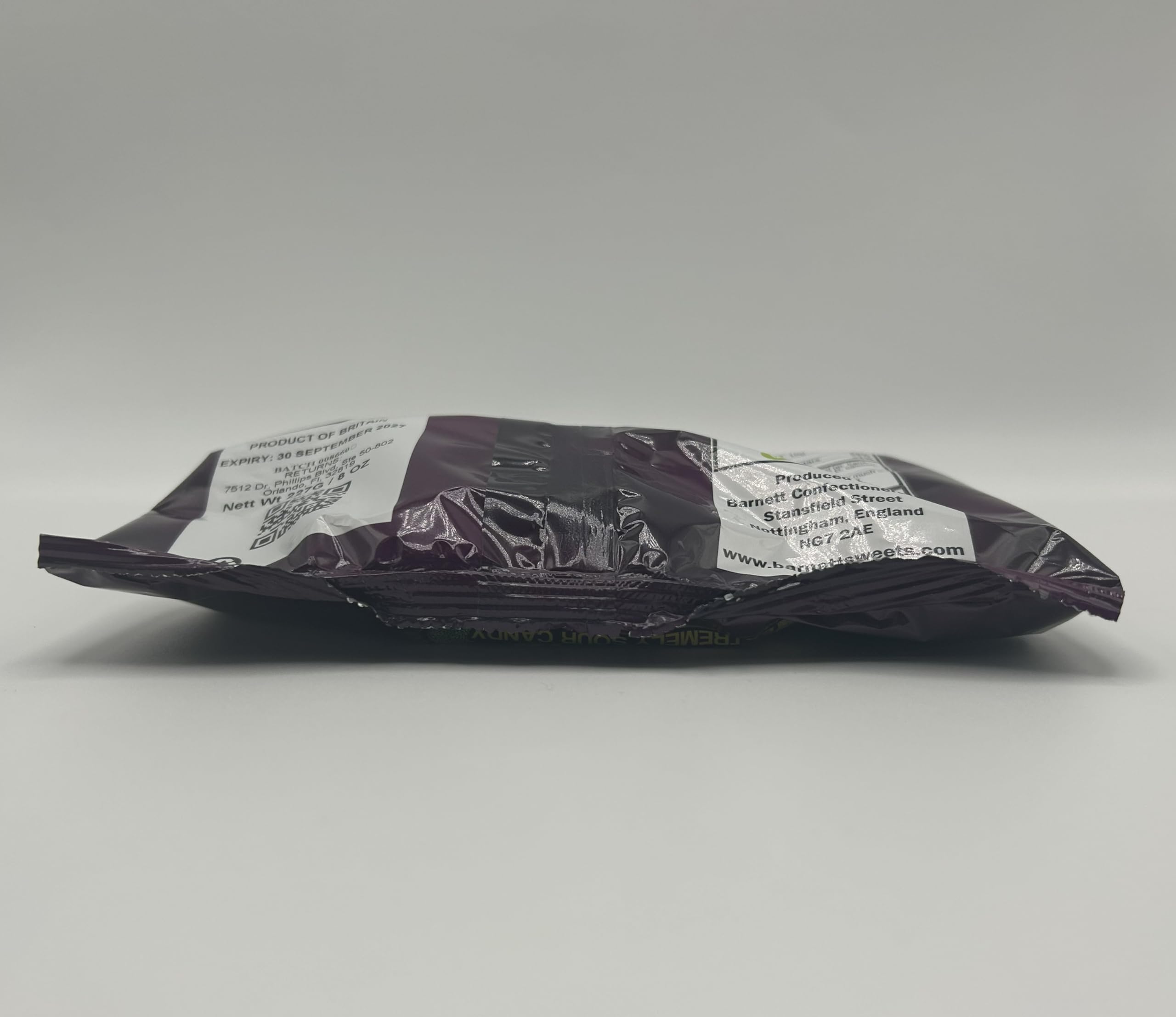 Barnetts candies held in hand to show 227g bag size and portioning