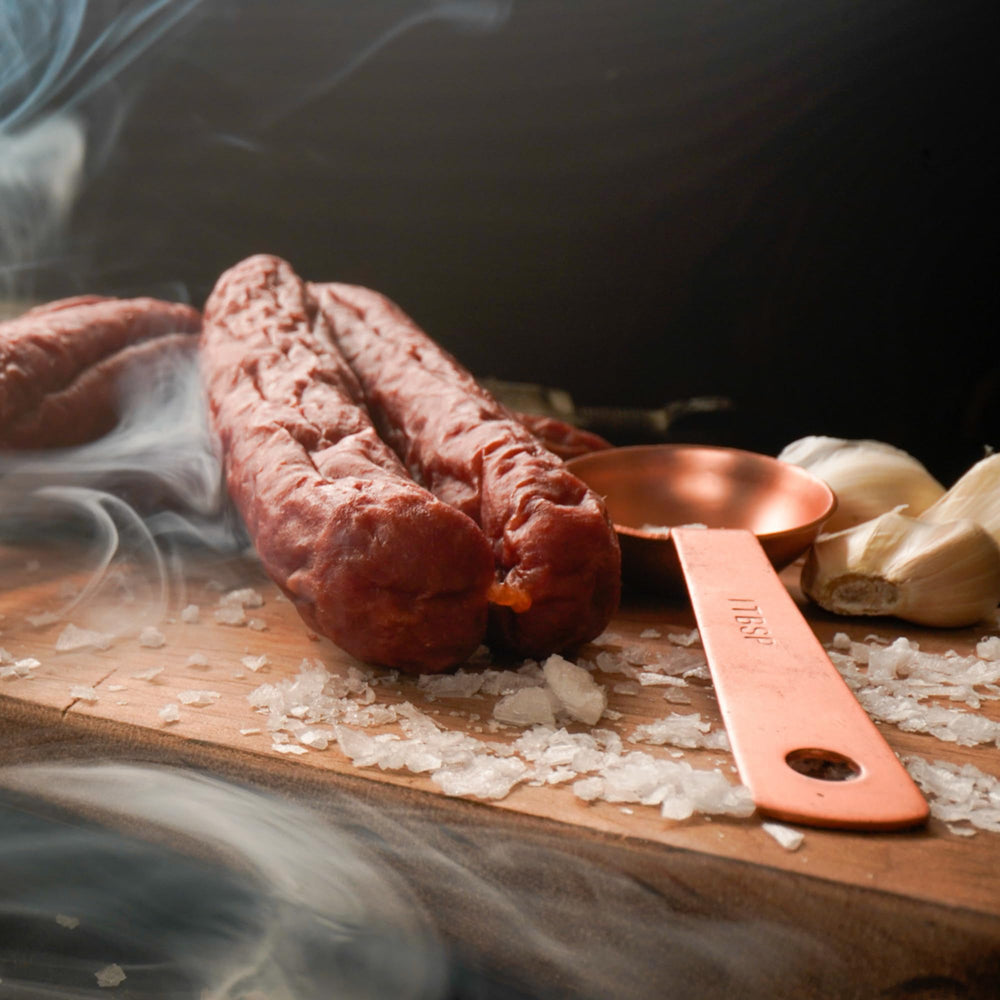 Bavarian Meats next to a ruler showing 1-ounce stick size for portion and packing reference