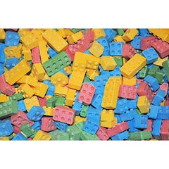 BAYSIDE CANDY hand holding a single block to show stackable shape and portion size