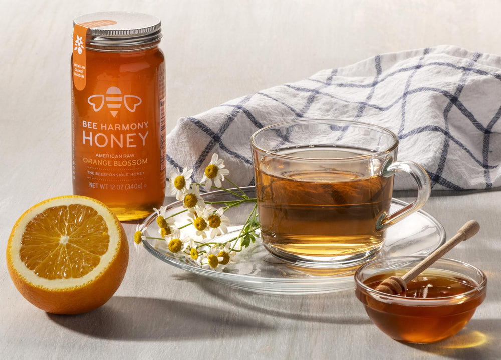 Bee Harmony honey on spoon mid-drizzle illustrating pourability and serving ease