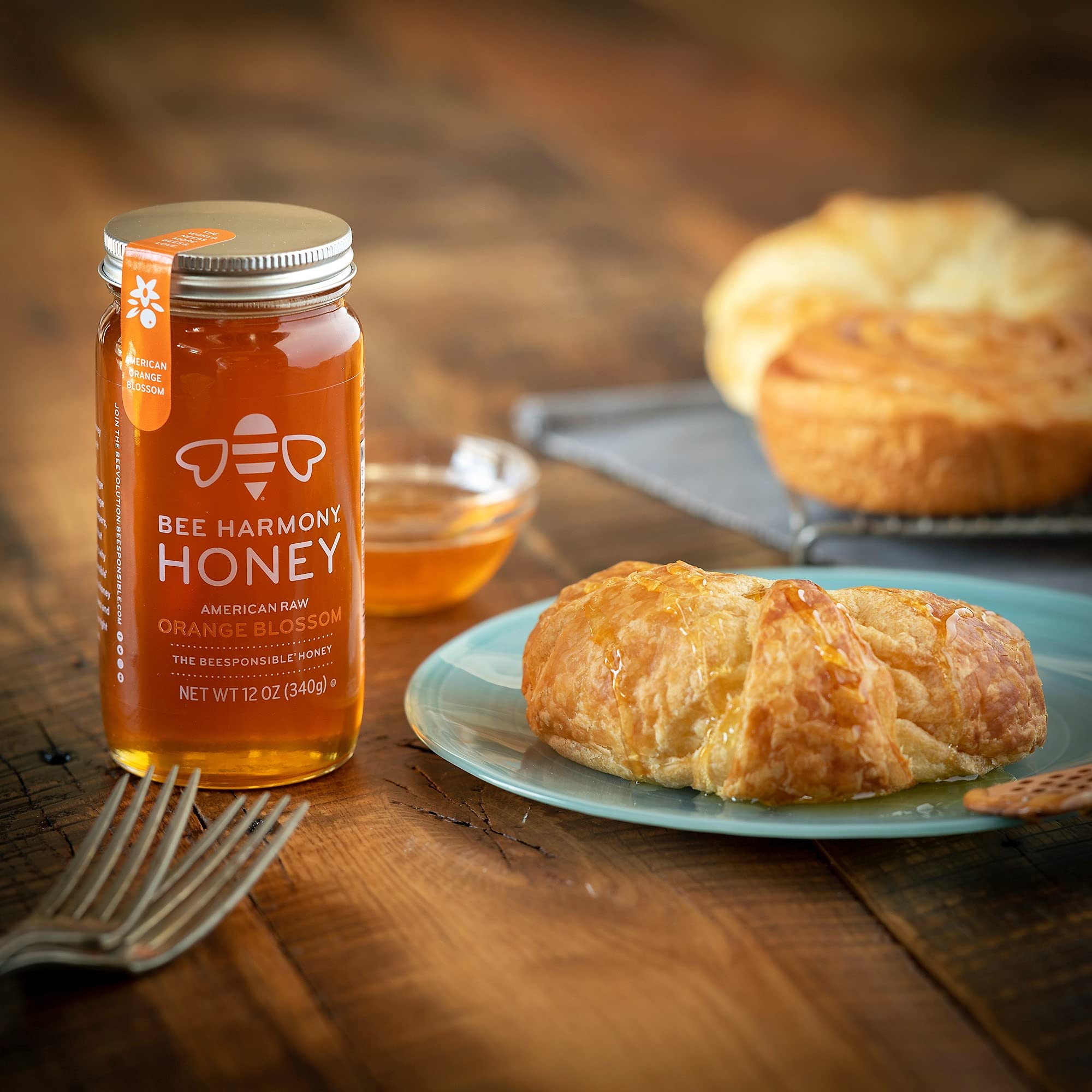Bee Harmony honey pouring from jar to show smooth texture and easy drizzle