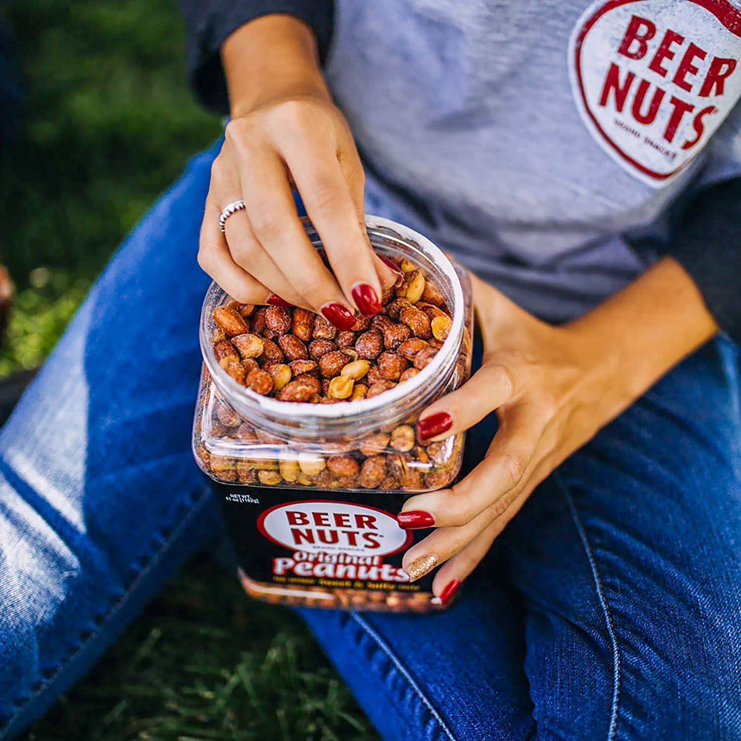 BEER NUTS jar next to a hand to show scale and generous 41 oz. quantity