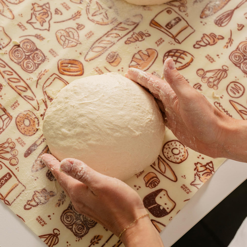 Bee's Wrap securing a long baguette to protect shape and reduce waste