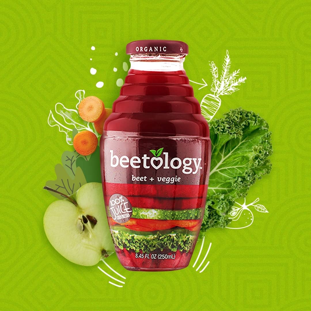 Fresh beets, apples, carrots, kale, celery flatlay with Beetology bottle showing ingredient transparency benefit