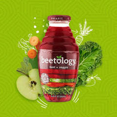 Fresh beets, apples, carrots, kale, celery flatlay with Beetology bottle showing ingredient transparency benefit