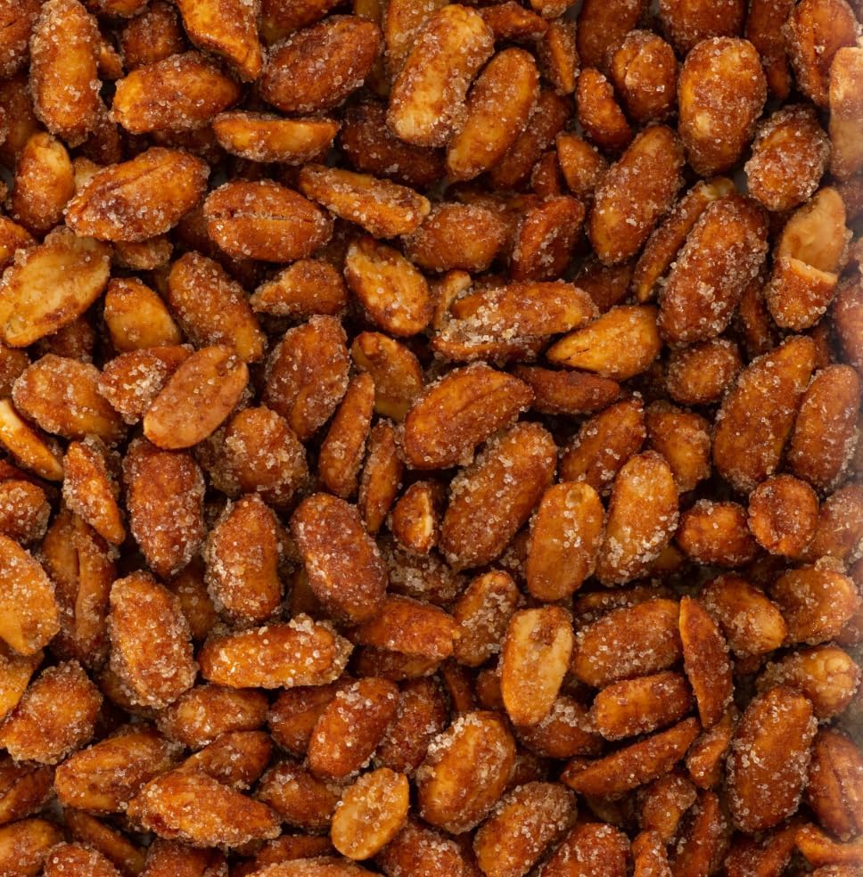 Belmont Peanuts size comparison in hand showing extra-large Virginia peanuts and substantial bite